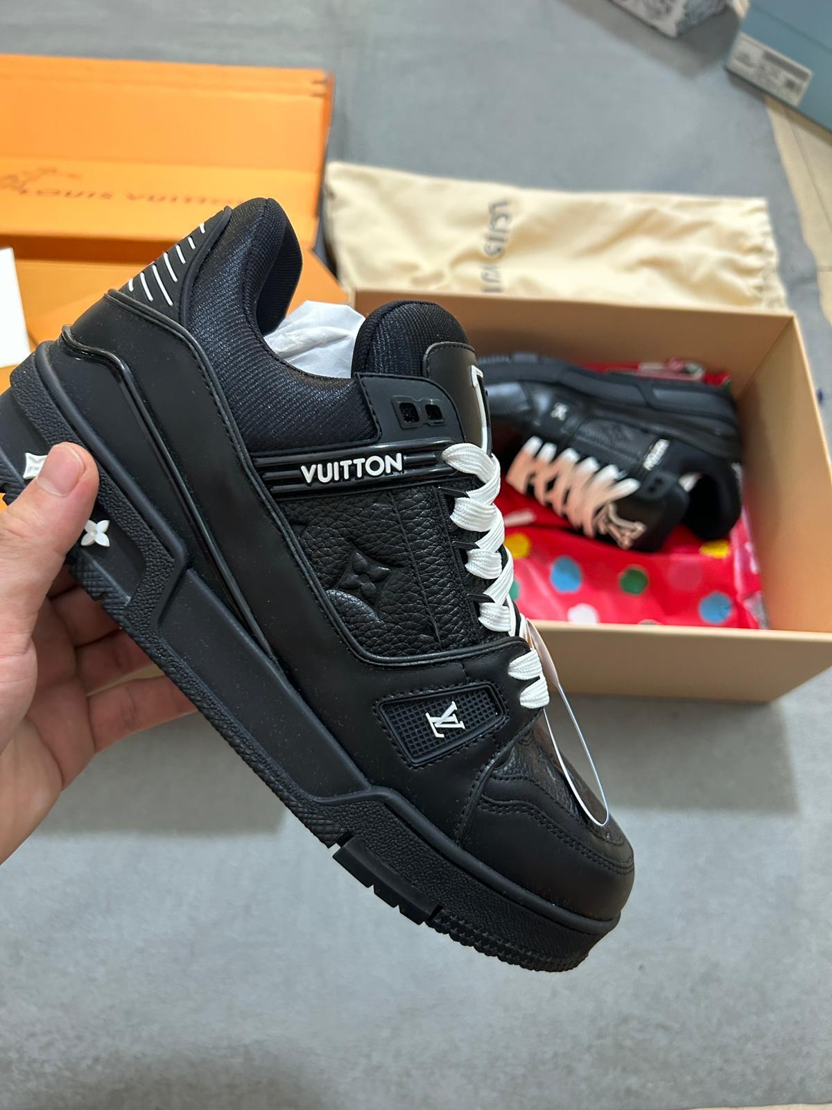 Side view of LV Trainer Nera sneakers highlighting minimalist silhouette and durable sole.